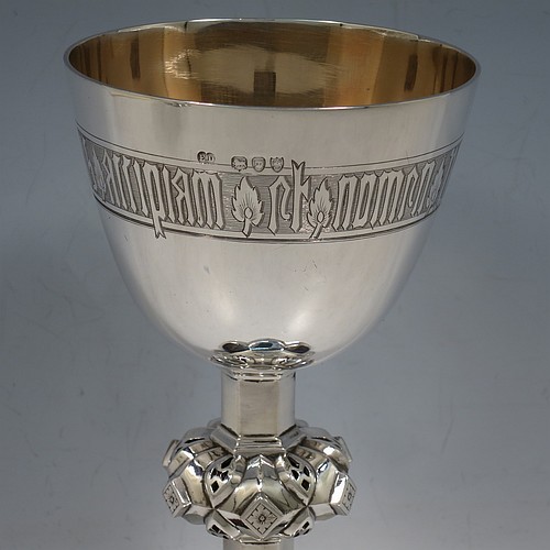 An Antique Victorian Sterling Silver pair of altar chalices, having plain round tapering cups with gold-gilt interiors and bands of hand-engraved Latin inscriptions, middle balusters with hand-chased work made to look as if mounted with six jewels, and sitting on spreading hexafoil feet with engraved Christograms. Made by Edward Dimes of London in 1893. The dimensions of this fine pair of hand-made antique silver chalices are height 20 cms (8 inches), width at base 13 cms (5 inches), and they weigh a total of approx. 778g (25 troy ounces).   