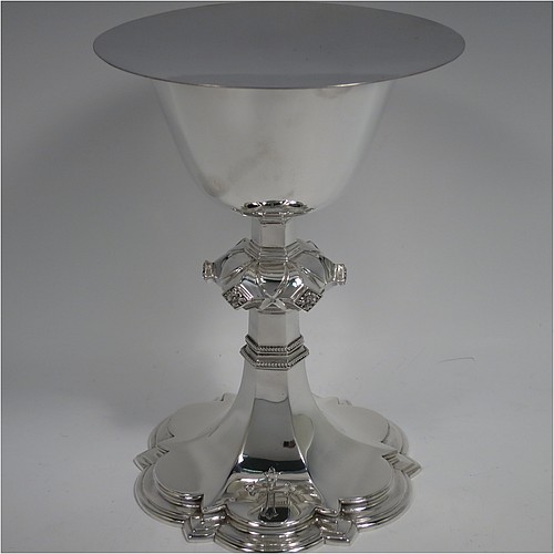 A Sterling Silver altar chalice and paten, having a plain round tapering cup, a middle baluster with hand-chased floral work made to look as if mounted with six jewels, and a spreading hexa-foil foot, with applied rope-twist borders, together with an original plain round paten. Made by Frederick Osborne and Co., of London in 1934. The dimensions of this fine hand-made silver chalice & paten are height 20 cms (8 inches), width at base 14 cms (5.5 inches), and it weighs approx. 659g (21 troy ounces).    