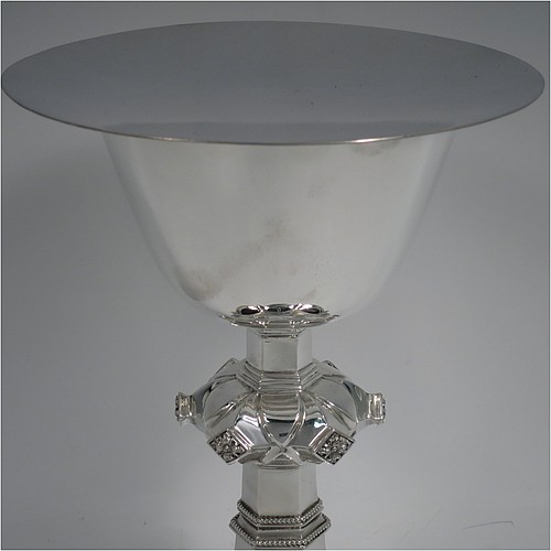 A Sterling Silver altar chalice and paten, having a plain round tapering cup, a middle baluster with hand-chased floral work made to look as if mounted with six jewels, and a spreading hexa-foil foot, with applied rope-twist borders, together with an original plain round paten. Made by Frederick Osborne and Co., of London in 1934. The dimensions of this fine hand-made silver chalice & paten are height 20 cms (8 inches), width at base 14 cms (5.5 inches), and it weighs approx. 659g (21 troy ounces).    