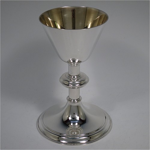 An Antique Victorian Sterling Silver altar chalice, having a plain round tapering cup with a gold-gilt interior, a round plain column with a middle baluster, and a spreading round pedestal foot with reeded border. Made by Blunt, Wray and Co., of London in 1897. The dimensions of this fine hand-made antique silver chalice are height 13 cms (5 inches), diameter of cup 8 cms (3.25 inches), and it weighs approx. 235g (7.6 troy ounces).    