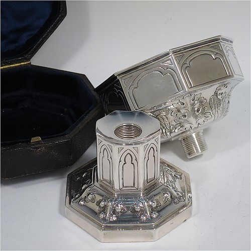 An Antique Victorian Sterling Silver very rare and unusual travelling chalice, in the shape of an octagonal shaped baptismal font, the top piece, which screws into the base, having a gold-gilt interior and hand-chased panels with anthemion leaves and angel faces, the pedestal base with matching panel work and leaves, and all in its original dark-blue satin and velvet-lined presentation box. Made by George Fox of London in 1863. The dimensions of this fine hand-made antique silver travelling chalice are height 10 cms (4 inches), diameter at top 9 cms (3.5 inches), with a total weight of approx. 172g (5.5 troy ounces).    