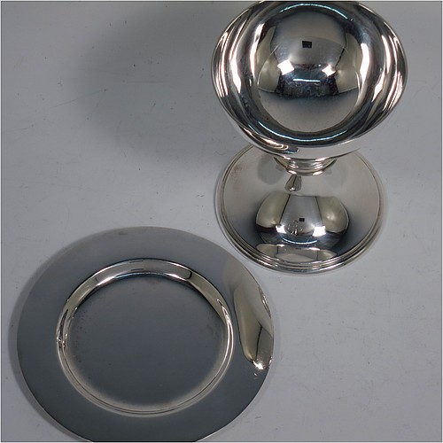 A small Sterling Silver altar chalice and paten, having a plain round bellied cup, a round column with a middle baluster, and a spreading round pedestal foot with reeded borders, together with a plain round original paten. Made by H. F. and Co. Ltd. of London in 1965. The dimensions of this fine hand-made silver chalice and paten are height 10 cms (4 inches), diameter of paten 11 cms (4.25 inches), with a total weight of approx. 203g (6.5 troy ounces). 