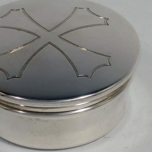 A heavy Sterling Silver Pyx box, having a plain round body, a pull-off lid with a hand-engraved Christogram, a gold-gilt interior, and sitting on a flat base. Made by H. F. and Co. Ltd., of London in 1965. The dimensions of this fine hand-made silver Pyx box are diameter 6.5 cms (2.75 inches), depth 3 cms (1.25 inches), and it weighs approx. 91g (3 troy ounces). 