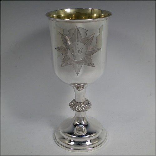 A large and handsome Antique Victorian Sterling Silver altar chalice, having a round straight-sided body with tucked under belly, an applied reeded top border, a gold-gilt interior, a middle baluster with fluted cabochon decoration, and a spreading round stepped pedestal foot. This beautiful silver chalice was made by Henry Holland of London in 1871. The dimensions of this fine hand-made antique silver altar chalice are height 23.5 cms (9.25 inches), diameter at lip 11 cms (4.25 inches), and it weighs approx. 382g (12.3 troy ounces). Please note that this has a classically engraved Christogram within sunburst on main body.