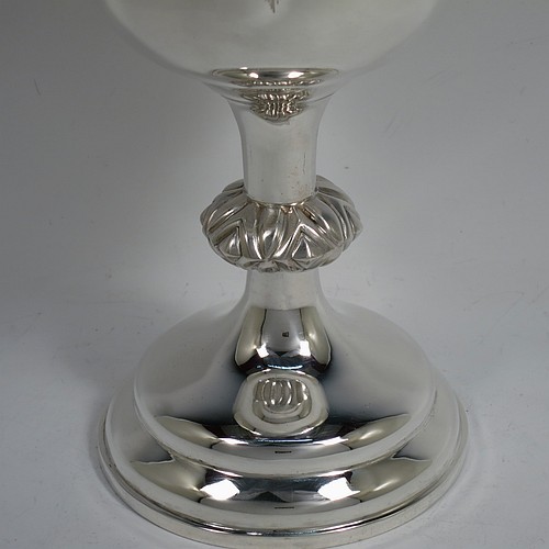 A large and handsome Antique Victorian Sterling Silver altar chalice, having a round straight-sided body with tucked under belly, an applied reeded top border, a gold-gilt interior, a middle baluster with fluted cabochon decoration, and a spreading round stepped pedestal foot. This beautiful silver chalice was made by Henry Holland of London in 1871. The dimensions of this fine hand-made antique silver altar chalice are height 23.5 cms (9.25 inches), diameter at lip 11 cms (4.25 inches), and it weighs approx. 382g (12.3 troy ounces). Please note that this has a classically engraved Christogram within sunburst on main body.