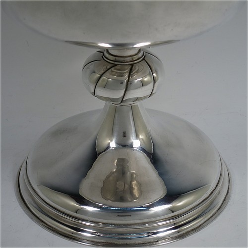 A very large and handsome Antique Edwardian Scottish Sterling Silver Ciborium, having a plain round body with a gold-gilt interior and applied reeded borders, sitting on a round pedestal foot with a swirl-fluted middle baluster, and a lift-off lid with double cruciform finial. Made by John Alexander Fettes of Glasgow in 1908. The dimensions of this fine hand-made and large antique silver ciborium and cover are height 28 cms (11 inches), diameter of cup 18.5 cms (7.25 inches), and it weighs a total of approx. 1,217g (39 troy ounces). Please note that this is the largest ciborium we have ever seen and is shown with a standard 75cl wine bottle for display purposes only and to give an indication of its size.