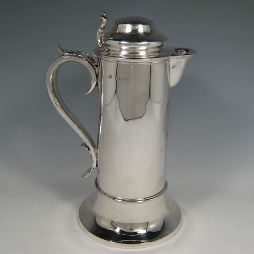 Antique Victorian sterling silver ecclesiastical wine / water flagon, having a plain round straight-sided body, that holds the original hand-cut crystal liner jar, together with a hinged domed lid and cast thumb-piece, a scroll handle, and sitting on a spreading collet foot. Made by Charles & George Fox of London in 1851. The dimensions of this fine hand-made antique silver flagon are height 26 cms (10.25 inches), length 18 cms (7 inches), and it weighs approx. 20 troy ounces (620g). Please note that the front of the main body has an engraved christogram.