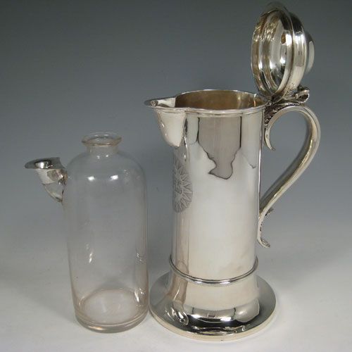 Antique Victorian sterling silver ecclesiastical wine / water flagon, having a plain round straight-sided body, that holds the original hand-cut crystal liner jar, together with a hinged domed lid and cast thumb-piece, a scroll handle, and sitting on a spreading collet foot. Made by Charles & George Fox of London in 1851. The dimensions of this fine hand-made antique silver flagon are height 26 cms (10.25 inches), length 18 cms (7 inches), and it weighs approx. 20 troy ounces (620g). Please note that the front of the main body has an engraved christogram.