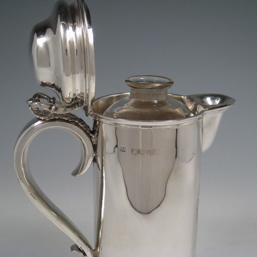 Antique Victorian sterling silver ecclesiastical wine / water flagon, having a plain round straight-sided body, that holds the original hand-cut crystal liner jar, together with a hinged domed lid and cast thumb-piece, a scroll handle, and sitting on a spreading collet foot. Made by Charles & George Fox of London in 1851. The dimensions of this fine hand-made antique silver flagon are height 26 cms (10.25 inches), length 18 cms (7 inches), and it weighs approx. 20 troy ounces (620g). Please note that the front of the main body has an engraved christogram.