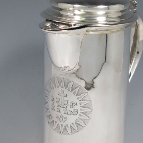 Antique Victorian sterling silver ecclesiastical wine / water flagon, having a plain round straight-sided body, that holds the original hand-cut crystal liner jar, together with a hinged domed lid and cast thumb-piece, a scroll handle, and sitting on a spreading collet foot. Made by Charles & George Fox of London in 1851. The dimensions of this fine hand-made antique silver flagon are height 26 cms (10.25 inches), length 18 cms (7 inches), and it weighs approx. 20 troy ounces (620g). Please note that the front of the main body has an engraved christogram.