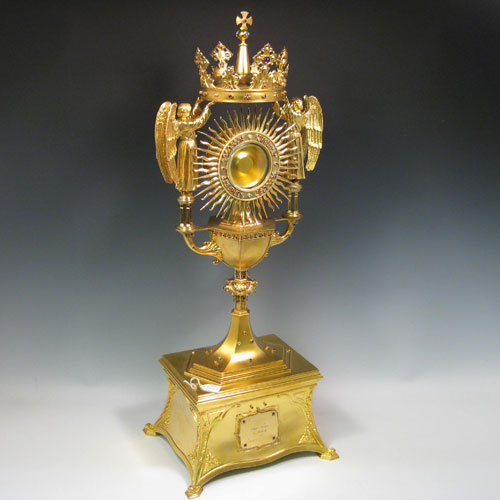 Sterling silver and gold-gilt monstrance for holding the consecrated host, inlaid with semi-precious stones, and all made by Blunt & Wray of London in 1933. Height 70 cms (27.5 inches), depth 21.5 cms (8.5 inches), width 26.5 cms (10.5 inches). Total weight approx. 170 troy ounces (5,270g).