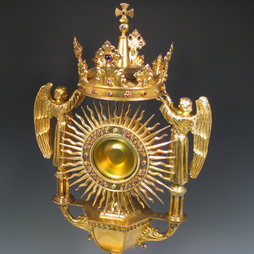 Sterling silver and gold-gilt monstrance for holding the consecrated host, inlaid with semi-precious stones, and all made by Blunt & Wray of London in 1933. Height 70 cms (27.5 inches), depth 21.5 cms (8.5 inches), width 26.5 cms (10.5 inches). Total weight approx. 170 troy ounces (5,270g).