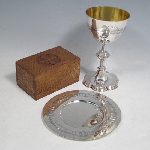 Antique Victorian sterling silver chalice and paten with wooden wafer box, having round bodies with hand-engraved christograms and bands diamond work, a gold-gilt interior to the chalice together with a hexafoil base, and the wafer box lid having a hand-engraved cross. Made by the Lias Brothers of London in 1873. The dimensions of this fine hand-made silver chalice and paten are height of chalice 14 cms (5.5 inches), diameter at lip 8 cms (3 inches), diameter of paten 13 cms (5 inches), with a total weight of silver being 236g (7.6 troy ounces).   