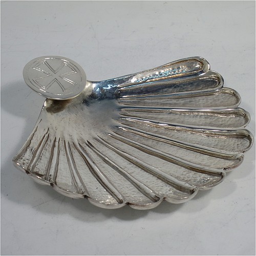 A very unusual cast Sterling Silver Anointing or Baptismal holy water Shell, having a traditional scallop shape, with hand-chased and hammered decoration, and a round handle with hand-engraved Christogram. Made in Birmingham in 1931. The dimensions of this fine hand-made Baptism or Anointing Shell are length 12 cms (4.75 inches), width 13 cms (5 inches), and weighing approx. 160g (5.2 troy ounces).    