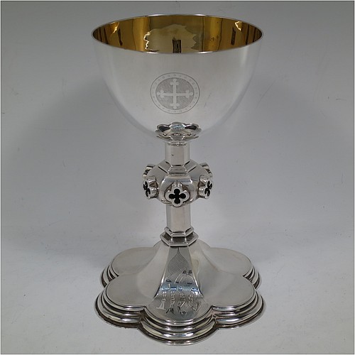 A very handsome and large Antique Victorian Sterling Silver altar chalice, having a plain round bellied cup with a gold-gilt interior, a hexagonal column with middle baluster having hand-pierced and applied cruciform decoration, and a lobed spreading hexagonal foot with a stepped lower border. Made by John Figg (poss.) of London in 1866. The dimensions of this fine hand-made antique silver altar chalice are height 20 cms (8 inches), diameter of cup 11cms (4.3 inches), diameter at base 13.5 cms (5.3 inches), and it weighs approx. 367g (12 troy ounces).  Please note that this has hand-engraved Christograms on the foot and cup. 