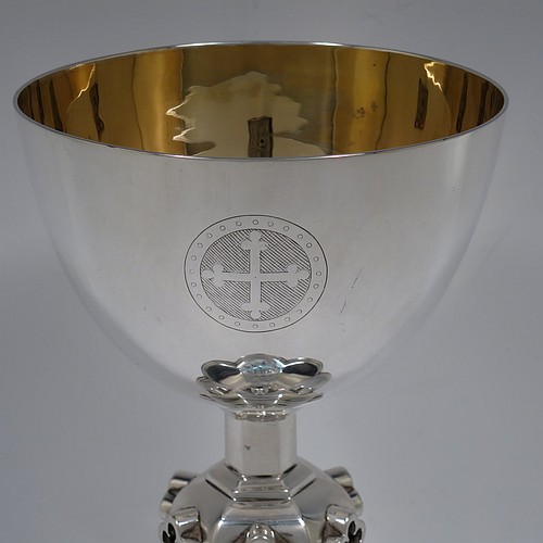 A very handsome and large Antique Victorian Sterling Silver altar chalice, having a plain round bellied cup with a gold-gilt interior, a hexagonal column with middle baluster having hand-pierced and applied cruciform decoration, and a lobed spreading hexagonal foot with a stepped lower border. Made by John Figg (poss.) of London in 1866. The dimensions of this fine hand-made antique silver altar chalice are height 20 cms (8 inches), diameter of cup 11cms (4.3 inches), diameter at base 13.5 cms (5.3 inches), and it weighs approx. 367g (12 troy ounces).  Please note that this has hand-engraved Christograms on the foot and cup. 