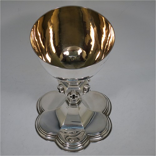 A very handsome and large Antique Victorian Sterling Silver altar chalice, having a plain round bellied cup with a gold-gilt interior, a hexagonal column with middle baluster having hand-pierced and applied cruciform decoration, and a lobed spreading hexagonal foot with a stepped lower border. Made by John Figg (poss.) of London in 1866. The dimensions of this fine hand-made antique silver altar chalice are height 20 cms (8 inches), diameter of cup 11cms (4.3 inches), diameter at base 13.5 cms (5.3 inches), and it weighs approx. 367g (12 troy ounces).  Please note that this has hand-engraved Christograms on the foot and cup. 