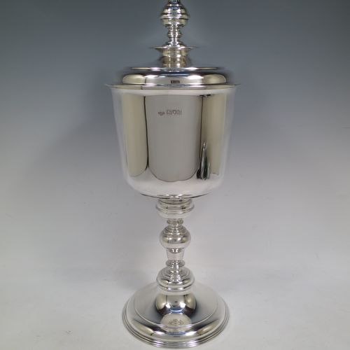 A very handsome, large, and heavy Antique Sterling Silver Ciborium, having a plain round body, a plain round lift-off lid with cast urn-shaped finial, a hand-chased central round baluster, and all sitting on a round stepped pedestal foot base. Made by Goldsmiths and Silversmiths of London in 1910. The dimensions of this fine hand-made antique silver ciborium are height 39 cms (15.3 inches), diameter of cup 15 cms (6 inches), and it weighs a total of approx. 1,552g (50 troy ounces).    