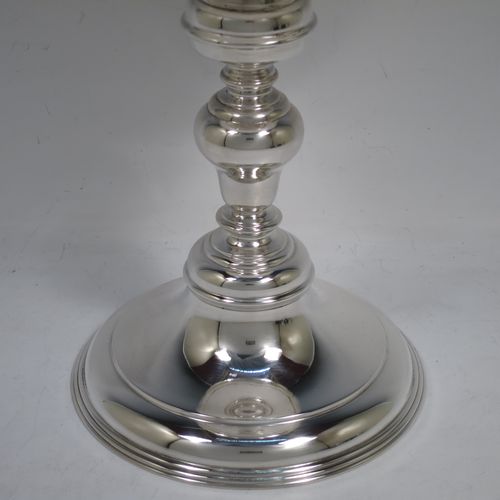 A very handsome, large, and heavy Antique Sterling Silver Ciborium, having a plain round body, a plain round lift-off lid with cast urn-shaped finial, a hand-chased central round baluster, and all sitting on a round stepped pedestal foot base. Made by Goldsmiths and Silversmiths of London in 1910. The dimensions of this fine hand-made antique silver ciborium are height 39 cms (15.3 inches), diameter of cup 15 cms (6 inches), and it weighs a total of approx. 1,552g (50 troy ounces).    