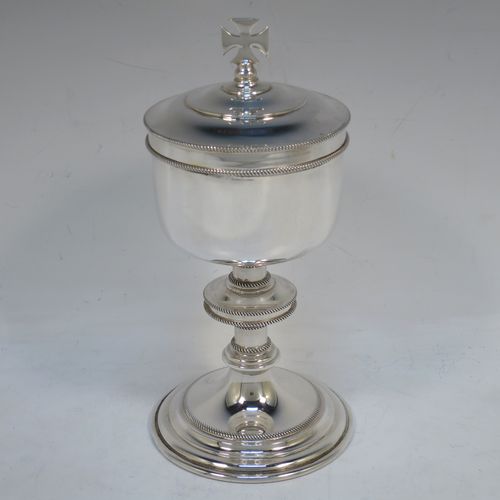 A handsome Sterling Silver Ciborium, having a plain round body with applied rope-twist borders and a gold-gilt interior, sitting on a matching pedestal foot with central baluster, and a lift-off lid with cruciform finial. Made by Vanpoulles Ltd. of London in 1962. The dimensions of this fine hand-made silver ciborium are height 19 cms (7.5 inches), diameter of cup 8.5 cms (3.3 inches), and the cup weighs approx. 264g (8.5 troy ounces).  