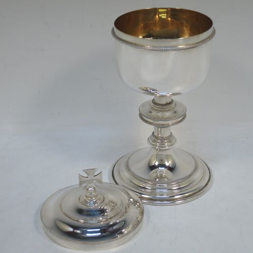 A handsome Sterling Silver Ciborium, having a plain round body with applied rope-twist borders and a gold-gilt interior, sitting on a matching pedestal foot with central baluster, and a lift-off lid with cruciform finial. Made by Vanpoulles Ltd. of London in 1962. The dimensions of this fine hand-made silver ciborium are height 19 cms (7.5 inches), diameter of cup 8.5 cms (3.3 inches), and the cup weighs approx. 264g (8.5 troy ounces).  