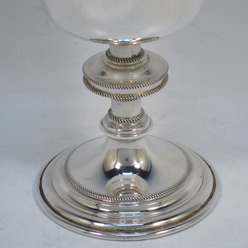 A handsome Sterling Silver Ciborium, having a plain round body with applied rope-twist borders and a gold-gilt interior, sitting on a matching pedestal foot with central baluster, and a lift-off lid with cruciform finial. Made by Vanpoulles Ltd. of London in 1962. The dimensions of this fine hand-made silver ciborium are height 19 cms (7.5 inches), diameter of cup 8.5 cms (3.3 inches), and the cup weighs approx. 264g (8.5 troy ounces).  