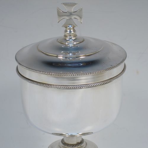 A handsome Sterling Silver Ciborium, having a plain round body with applied rope-twist borders and a gold-gilt interior, sitting on a matching pedestal foot with central baluster, and a lift-off lid with cruciform finial. Made by Vanpoulles Ltd. of London in 1962. The dimensions of this fine hand-made silver ciborium are height 19 cms (7.5 inches), diameter of cup 8.5 cms (3.3 inches), and the cup weighs approx. 264g (8.5 troy ounces).  