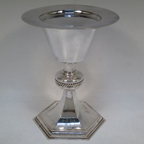 A very handsome Sterling Silver altar chalice and paten, having a round hand-hammered tapering cup with a gold-gilt interior, a middle baluster with an applied gadroon band, and a spreading hexagonal pedestal foot with applied double gadroon borders, and the paten with matching hand-hammered decoration. Made by Hurst, Franklin and Co. Ltd., of London in 1956. The dimensions of this fine hand-made silver chalice and paten are height 20 cms (8 inches), width at base 13.5 cms (5.5 inches), diameter of paten 15 cms (6 inches), and it weighs approx. 326g (10.5 troy ounces).   