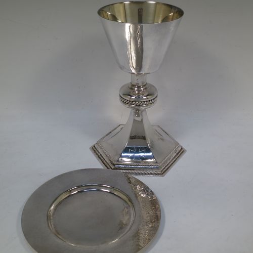 A very handsome Sterling Silver altar chalice and paten, having a round hand-hammered tapering cup with a gold-gilt interior, a middle baluster with an applied gadroon band, and a spreading hexagonal pedestal foot with applied double gadroon borders, and the paten with matching hand-hammered decoration. Made by Hurst, Franklin and Co. Ltd., of London in 1956. The dimensions of this fine hand-made silver chalice and paten are height 20 cms (8 inches), width at base 13.5 cms (5.5 inches), diameter of paten 15 cms (6 inches), and it weighs approx. 326g (10.5 troy ounces).   