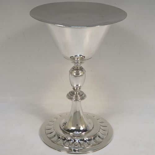 A very elegant Sterling Silver altar chalice and paten, having a plain round tapering cup, a middle plain round stepped baluster, sitting on a round pedestal foot with a band of hand-chased fluted decoration, together with an original plain round paten. This beautiful silver chalice and paten was made in London in 1957. The dimensions of this fine hand-made silver chalice and paten are height of chalice 19.5 cms (7.75 inches), diameter of cup at lip 10 cms (4 inches), diameter of paten 13.5 cms (5.3 inches), and with a total weight of approx. 507g (16.4 troy ounces).   