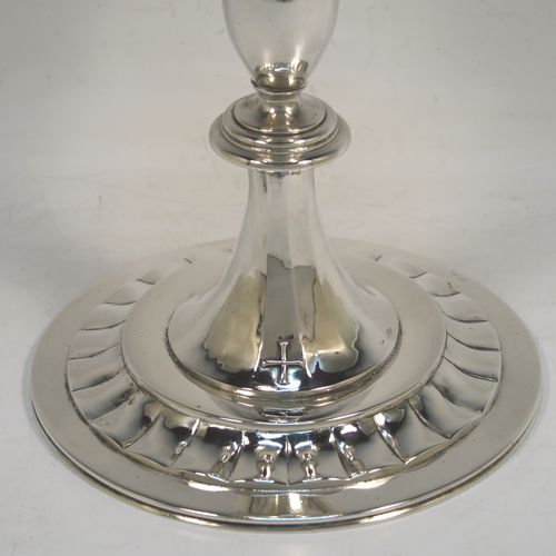 A very elegant Sterling Silver altar chalice and paten, having a plain round tapering cup, a middle plain round stepped baluster, sitting on a round pedestal foot with a band of hand-chased fluted decoration, together with an original plain round paten. This beautiful silver chalice and paten was made in London in 1957. The dimensions of this fine hand-made silver chalice and paten are height of chalice 19.5 cms (7.75 inches), diameter of cup at lip 10 cms (4 inches), diameter of paten 13.5 cms (5.3 inches), and with a total weight of approx. 507g (16.4 troy ounces).   