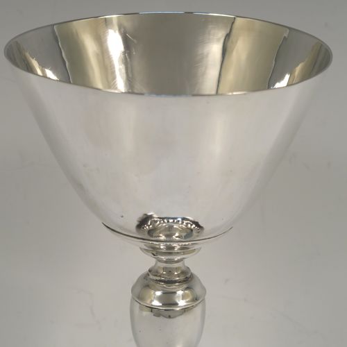 A very elegant Sterling Silver altar chalice and paten, having a plain round tapering cup, a middle plain round stepped baluster, sitting on a round pedestal foot with a band of hand-chased fluted decoration, together with an original plain round paten. This beautiful silver chalice and paten was made in London in 1957. The dimensions of this fine hand-made silver chalice and paten are height of chalice 19.5 cms (7.75 inches), diameter of cup at lip 10 cms (4 inches), diameter of paten 13.5 cms (5.3 inches), and with a total weight of approx. 507g (16.4 troy ounces).   