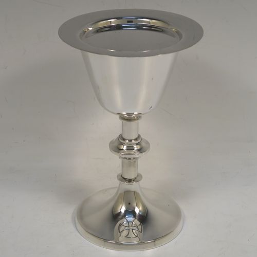 A handsome Sterling Silver altar chalice and paten, having a plain round tapering cup with a gold-gilt interior, a middle plain round baluster, sitting on a round pedestal foot, and a matching plain round paten. This beautiful silver chalice and paten were made by A. E. Jones of Birmingham in 1962. The dimensions of this fine hand-made silver chalice and paten are height of chalice 15 cms (6 inches), diameter of paten 10 cms (4 inches), and with a total weight of approx. 251g (8 troy ounces).   