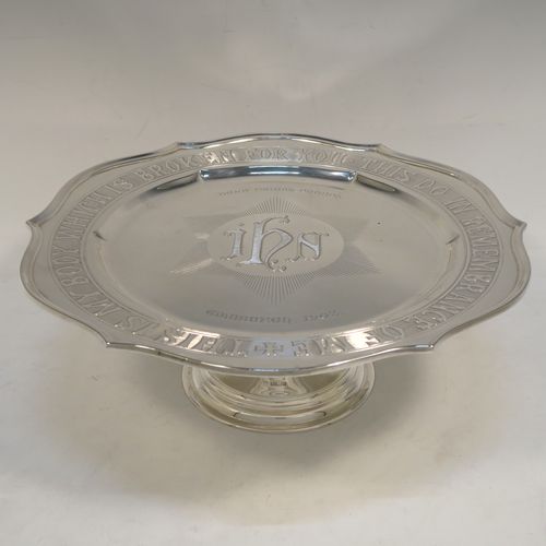 A very handsome and large Antique Edwardian Sterling Silver altar tazza dish for serving the consecrated communion wafers, having a round shaped body with a hand-engraved central Christogram and an engraved border with This Is My Body Which Is Broken For You - This Do In Remembrance Of Me, and all sitting on a plain round pedestal foot. This elegant communion tazza dish was made by Thomas Bradbury of Sheffield in 1902. The dimensions of this fine hand-made antique silver tazza communion dish are diameter 30.5 cms (12 inches), height 11.5 cms (4.5 inches), and it weighs approx. 1,095g (35 troy ounces).  