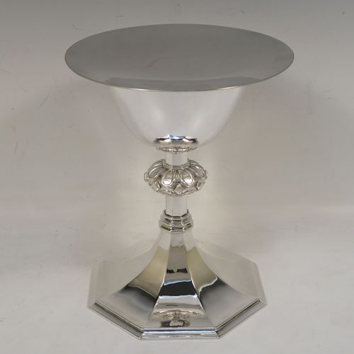 A very handsome Sterling Silver altar chalice and paten, having a round tapering cup with a gold-gilt interior, a middle baluster with applied jewel and band decoration, and a spreading hexagonal pedestal foot, together with an original plain round paten. This elegant silver chalice and paten was made by William F. Knight Ltd., of London in 1953. The dimensions of this fine hand-made silver chalice and paten are height 19 cms (7.5 inches), diameter of paten 15.5 cms (6 inches), and it weighs approx. 705g (22.5 troy ounces).   