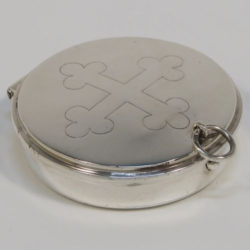 A handsome Sterling Silver Pyx box, having a plain round body, a hinged lid with a hand-engraved Christogram cross, and a clasp with ring handle. This elegant sterling silver Pyx box was made by A. R. Mowbray of London in 1953. The dimensions of this fine hand-made silver Pyx box are diameter 5 cms (2 inches), depth 1.2 cms (0.47 inches), and it weighs approx. 30g (1 troy ounce).   