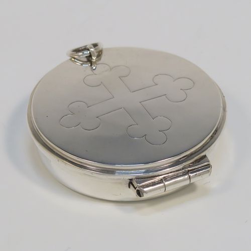 A handsome Sterling Silver Pyx box, having a plain round body, a hinged lid with a hand-engraved Christogram cross, and a clasp with ring handle. This elegant sterling silver Pyx box was made by A. R. Mowbray of London in 1953. The dimensions of this fine hand-made silver Pyx box are diameter 5 cms (2 inches), depth 1.2 cms (0.47 inches), and it weighs approx. 30g (1 troy ounce).   