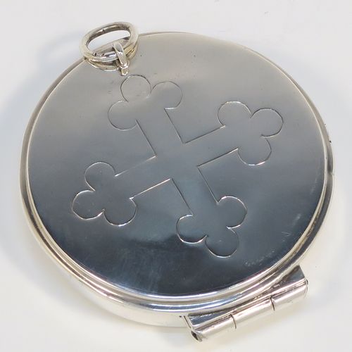 A handsome Sterling Silver Pyx box, having a plain round body, a hinged lid with a hand-engraved Christogram cross, and a clasp with ring handle. This elegant sterling silver Pyx box was made by A. R. Mowbray of London in 1953. The dimensions of this fine hand-made silver Pyx box are diameter 5 cms (2 inches), depth 1.2 cms (0.47 inches), and it weighs approx. 30g (1 troy ounce).   