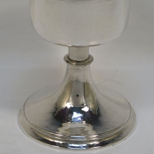 A small but handsome Sterling Silver Ciborium, having a round body with hand-hammered or planished decoration and reeded borders, a plain round lift-off lid with a cruciform finial, and all sitting on a round pedestal foot base. This elegant silver ciborium was made by John Wippell and Co. Ltd., of London in 1943. The dimensions of this fine hand-made silver ciborium are height 14.5 cms (5.75 inches), diameter of cup 7.5 cms (3 inches), and it weighs a total of approx. 237g (7.6 troy ounces).