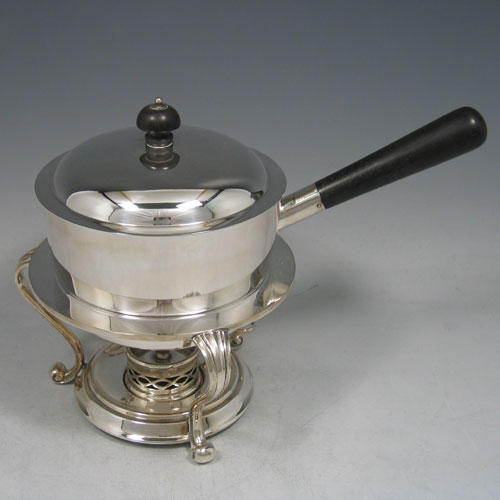    Edwardian silver plated egg coddler with wooden handle, burner stand, and internal egg holder, made in ca. 1900. Height 17 cms, width 13 cms.