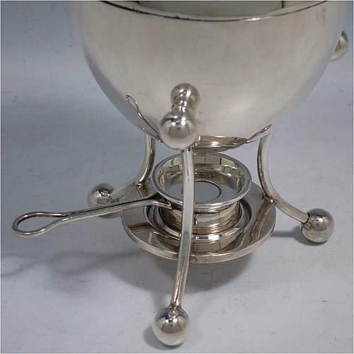 A rare Antique Edwardian Sterling Silver egg coddler, having a plain round body, with lift-off lid and wooden finial, sitting in a wire-work frame with ball terminals, an interior egg-holder for four eggs, and an original burner, all sitting on four ball feet. Made by Mappin & Webb of Sheffield in 1907. The dimensions of this fine hand-made antique silver egg coddler are height 23 cms (9 inches), diameter 11 cms (4.3 inches), and it weighs approx. 510g (16.5 troy ounces).   