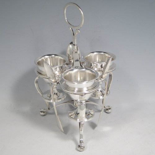 Antique Victorian sterling silver egg cruet set, having three removable plain round egg cups, and loop handle, all in a frame stand sitting on three scroll cushioned feet. The silver stand and egg cups are all made by Samuel Whitford of London in 1839, whilst the four spoons are in silver-plate. The dimensions of this fine hand-made silver egg cruet set are height 20 cms (8 inches), width 13.5 cms (5.3 inches), with a total weight of approx. 381g (12.3 troy ounces).   