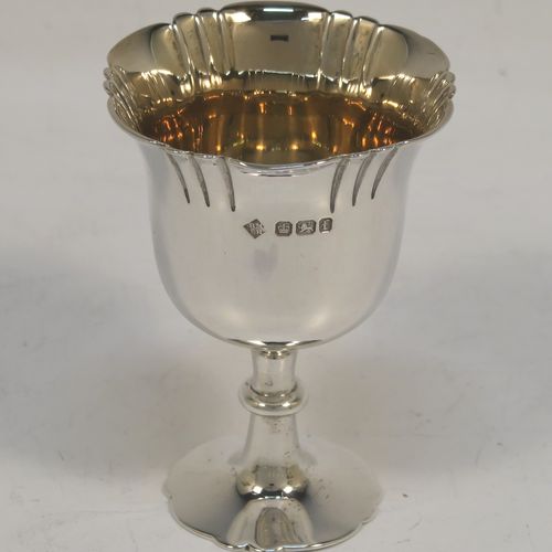 A very pretty Antique Victorian Sterling Silver egg cruet set with hand-chased fluted and shell decoration, having egg cups with gold-gilt interiors, and a cast shell and scroll loop handle attached to a round base sitting on four cast scrolled feet. This beautiful antique silver egg cruet set was made by Martin Hall and Co., of Sheffield in 1892 / 1898 (two of the egg cups are from 1892). The dimensions of this fine hand-made silver egg cruet set are height 18 cms (7 inches), the base is 15 cms (6 inches) in diameter, and the total weight is approx. 505g (16.3 troy ounces).  