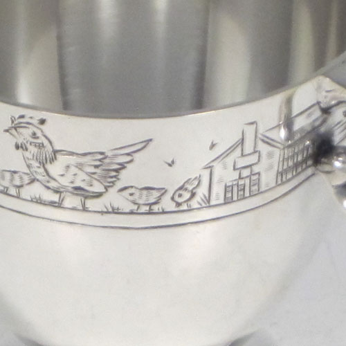 Sterling silver egg cup, having a plain round body with tapering sides, with a hand-engraved top border (showing ducks, ducklings, reeds, chickens, and chicks), with two scroll side-handles, and sitting on a pedestal foot. Made by R.W. Brookes for Harrods, London, in 1925. The dimensions of this fine hand-made silver egg cup are height 4.5 cms (1.75 inches), width 7 cms (2.75 inches), and it weighs approx. 44g (1.4 troy ounces).