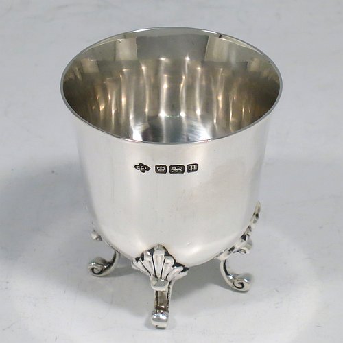 An Antique Edwardian Sterling Silver egg cup, having a plain round body with tapering sides, sitting on four cast foliate feet. Made by Charles Clement Pilling of Sheffield in 1907. The dimensions of this fine hand-made silver egg cup are height 5 cms (2 inches), diameter 4.5 cms (1.75 inches), and it weighs approx. 50g (1.6 troy ounces).   