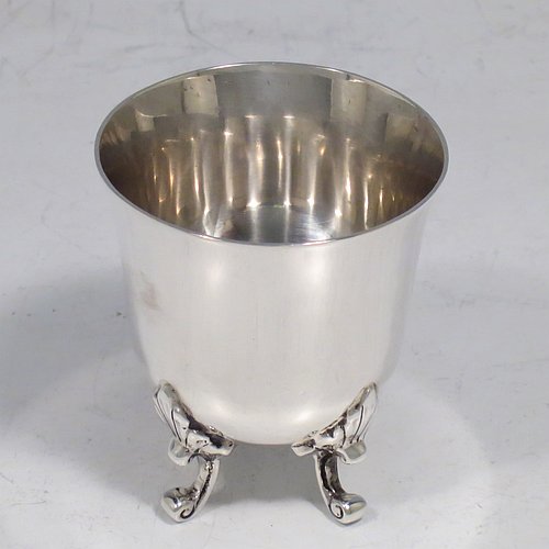 An Antique Edwardian Sterling Silver egg cup, having a plain round body with tapering sides, sitting on four cast foliate feet. Made by Charles Clement Pilling of Sheffield in 1907. The dimensions of this fine hand-made silver egg cup are height 5 cms (2 inches), diameter 4.5 cms (1.75 inches), and it weighs approx. 50g (1.6 troy ounces).   