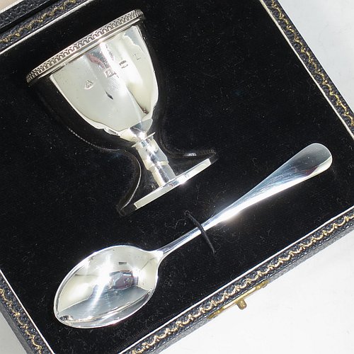 A Sterling Silver egg cup and spoon christening set, having a hand-chased panelled round egg cup, with an applied bead border, and a plain Old English pattern spoon. All fitted in their original cream satin and black velvet-lined presentation box. Made by the Adie Brothers of Birmingham in 1974. The dimensions of this fine hand-made silver egg cup & spoon christening set are length of spoon 11.5 cms (4.5 inches), height of egg cup 6 cms (2.3 inches), and the total weight is approx. 81g (2.6 troy ounce).   