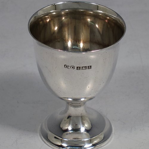 A Sterling Silver christening set, having a plain round egg cup, and a plain pattern spoon. All fitted in their original cream satin and blue velvet-lined presentation box. Made in Birmingham in 1964. The dimensions of this fine hand-made silver christening set are length of spoon 11 cms (4.3 inches), height of egg cup 6.5 cms (2.5 inches), and the total weight is approx. 50g (1.6 troy ounce).    