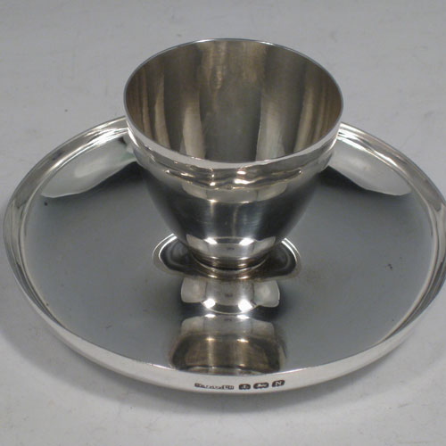    Sterling silver pair of Art Deco egg cups, having plain round bodies, attached to plain round concave stands. Made in Birmingham in 1937. Diameter 9.5 cms (3.75 inches), height 4.5 cms (1.75 inches). Total weight approx. 127g (4.1 troy ounces).