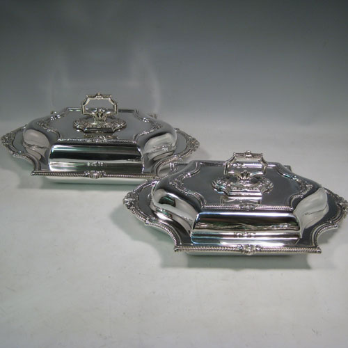 Antique Victorian silver-plated pair of entree dishes with covers, having bayonet-fit removable handles, very pretty shaped rectangular bodies, with gadroon and floral borders. Made by James Dixon and Sons in ca. 1870. Length 36 cms (14 inches), height including handle 13 cms (5 inches), width 22 cms (8.5 inches).